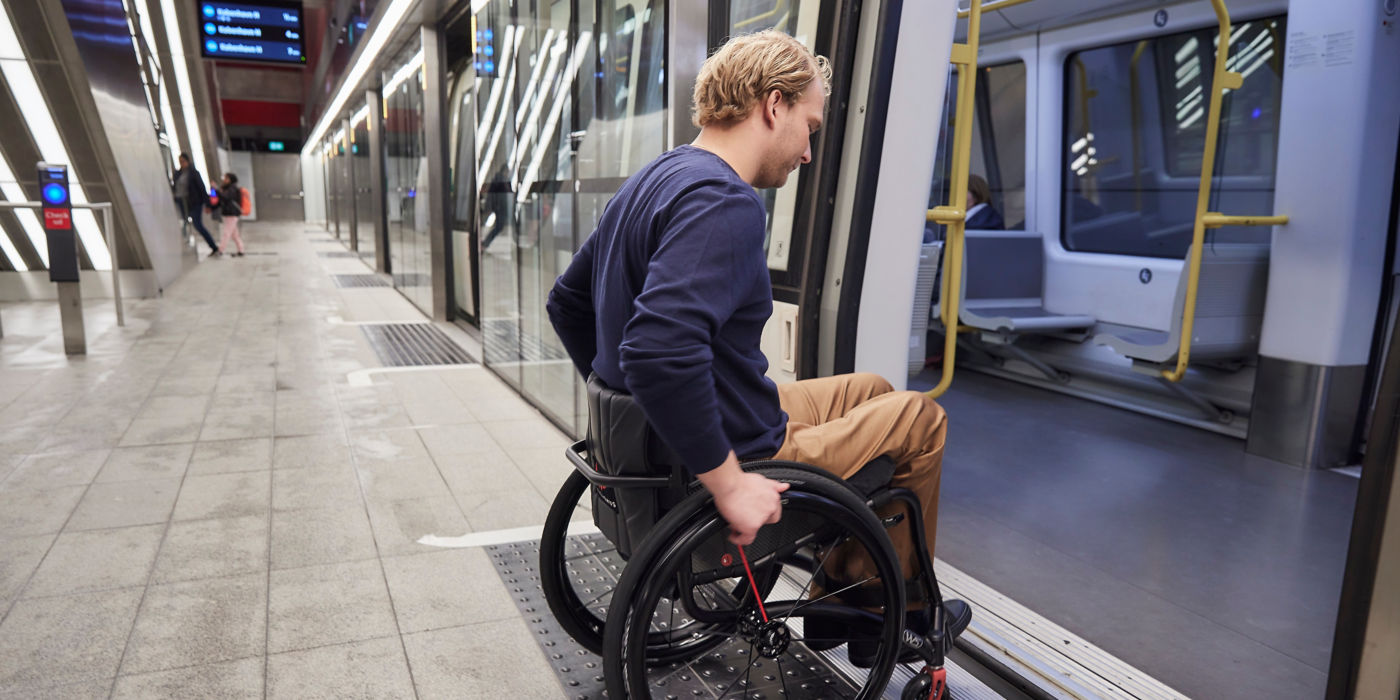Man in wheelchair getting in the metro.